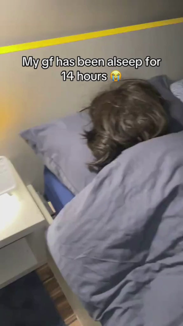 A cool-mist humidifier releasing soft mist beside a bed, with relaxing sound icons showing white noise and nature sounds.